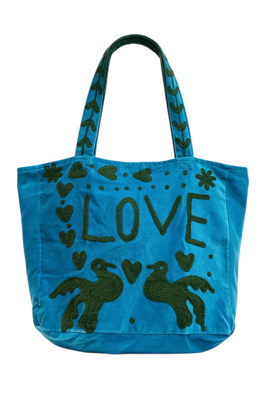 Trestles Clothing Company blue velvet tote bag featuring green embroidered LOVE text and whimsical bird designs.